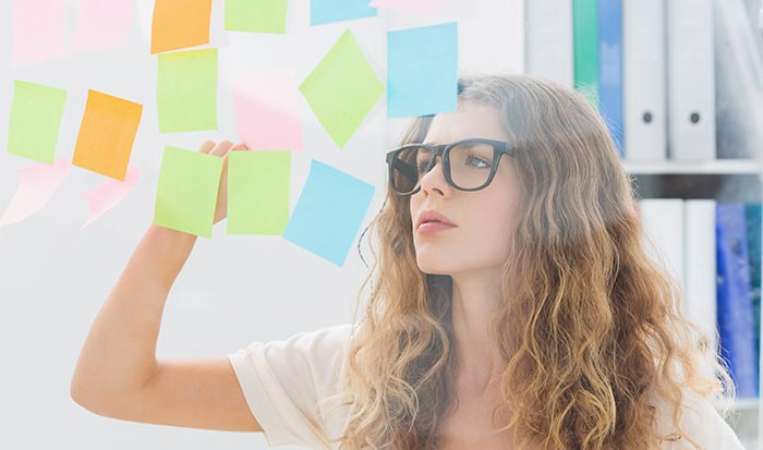 Woman Reading Post-It notes