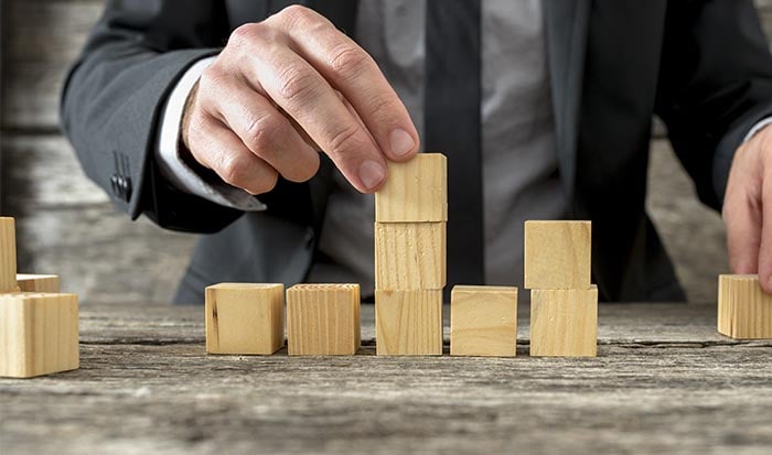 man building with blocks
